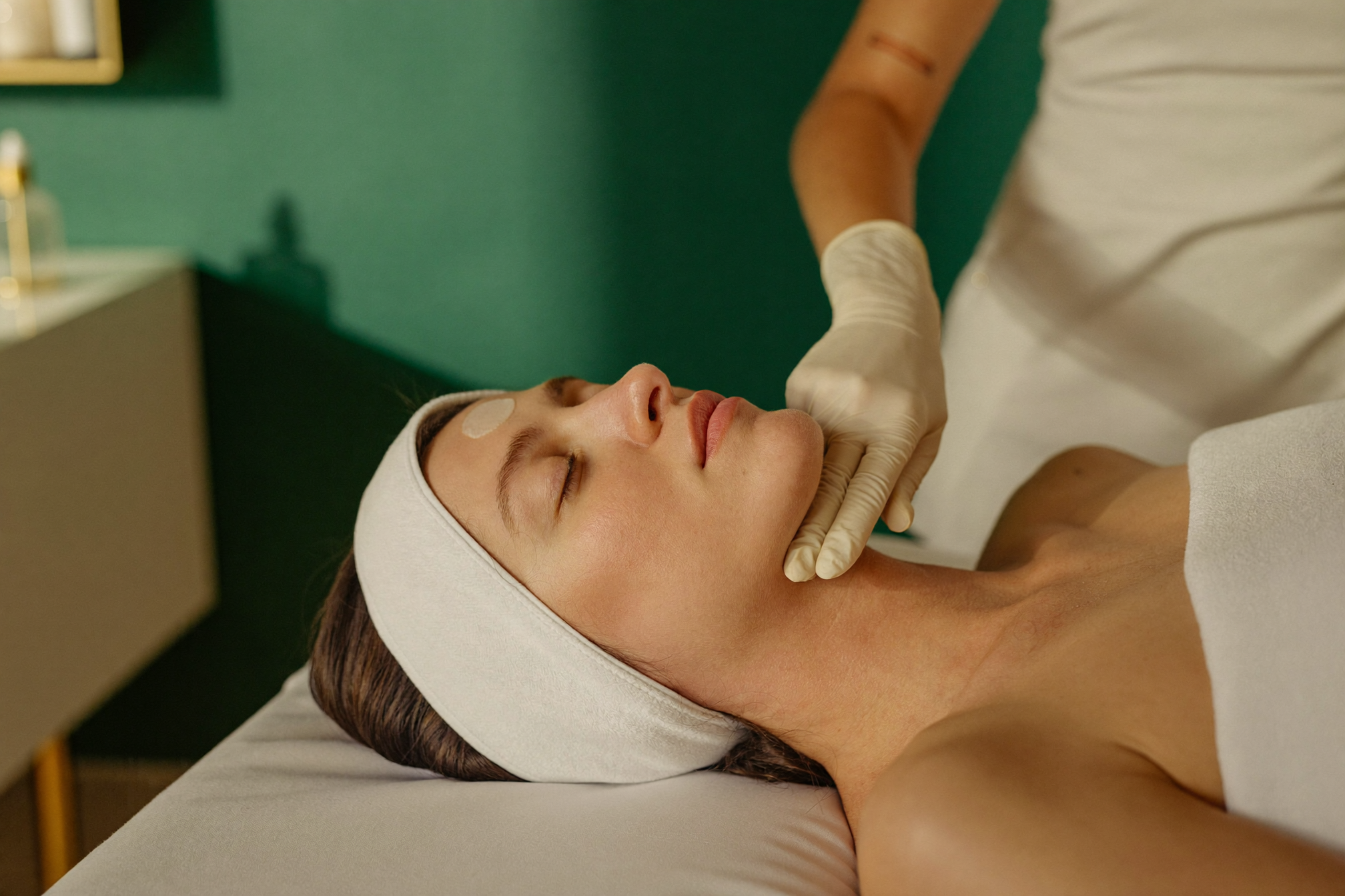 Esthetician performing a facial treatment at The Whole You Wellness Center in St. Peters, MO