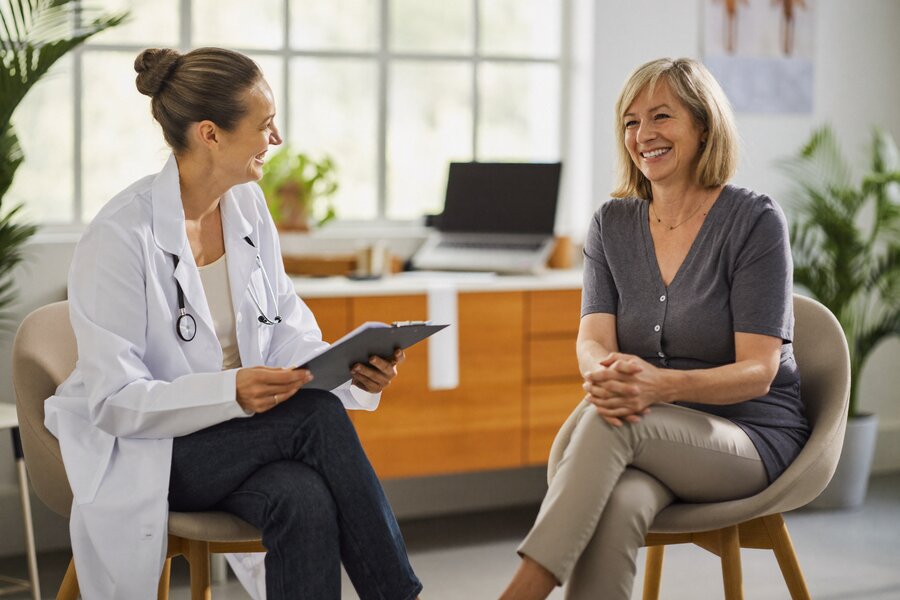 Physician having a relaxed, unhurried conversation with a patient during a Direct Primary Care visit at The Whole You Wellness Center