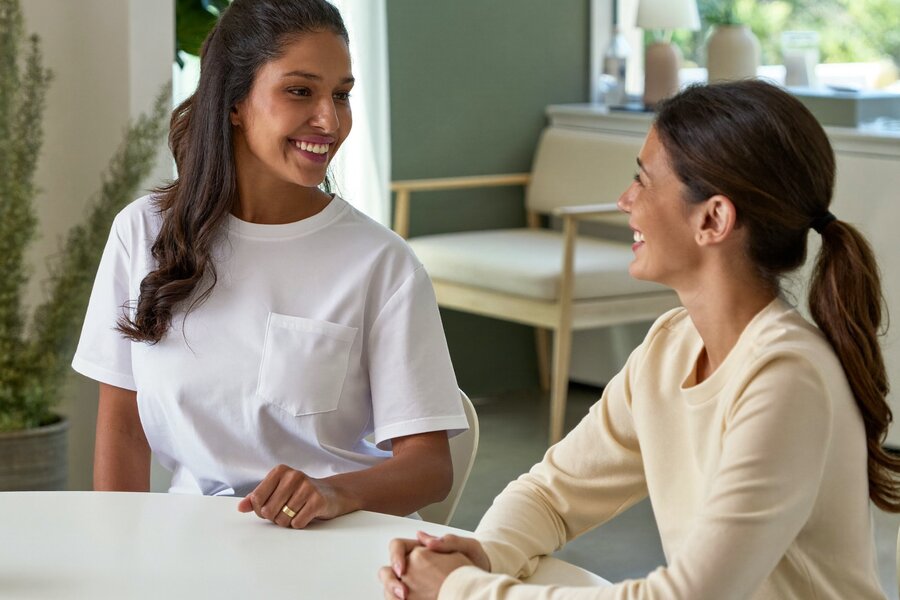 A supportive, reassuring moment between provider and patient during a body contouring consultation at The Whole You Wellness Center